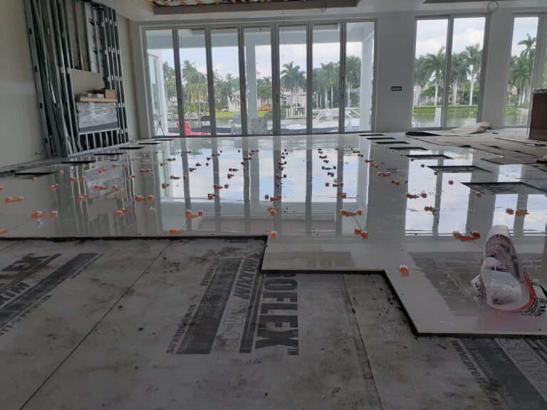 Luxury large-format marble floor installation in modern waterfront home, Naples Florida floor remodeling services.
