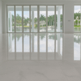 Luxury large-format marble floor installation in modern waterfront home, Naples Florida floor remodeling services.